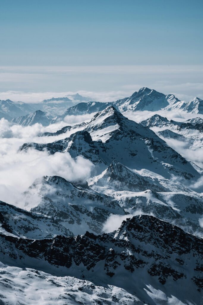Dramatic view of the snow-covered Swiss Alps under a clear sky, perfect for nature photography enthusiasts.